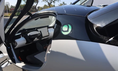 Futuristic electric vehicle with open gull-wing door