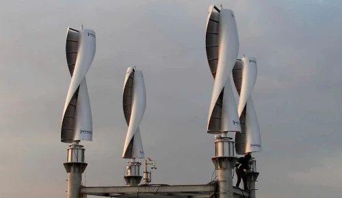 Vertical wind turbines on a rooftop generating electricity.