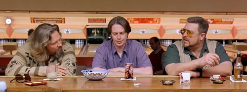 Three men sitting in a bowling alley bar.